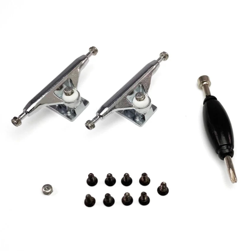 Set of fingerboard trucks. The trucks are made of steel. The axles are connected by a kingpin. The trucks have two white bushings. The bushings allow the trucks to turn smoothly. The trucks are a raw steel or silver color..