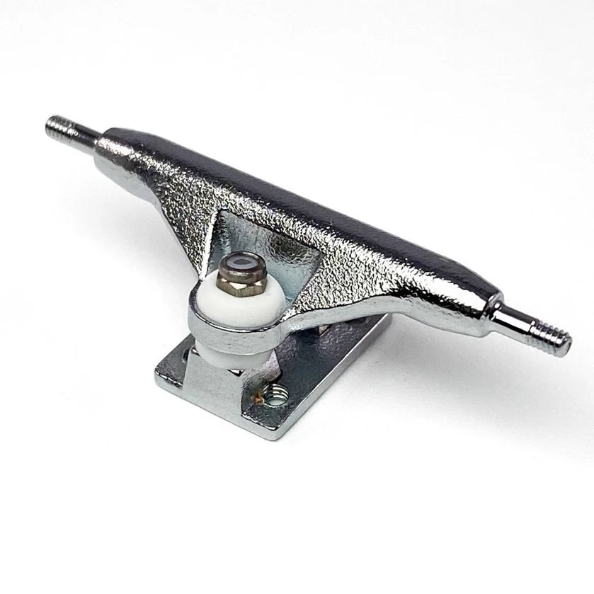 Close up of a single fingerboard truck. The axle is connected to the base by a kingpin and has 2 bushings to help turn smoothly. The truck is a raw steel or silver color.