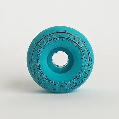 Boardy Cakes Therm O Thane Cold Shift Skateboard Wheels; Thermo Blue color for a clean and versatile look; Features Therm O Thane technology that changes color based on temperature; Side profile shown in alternate angle for visual reference; 
