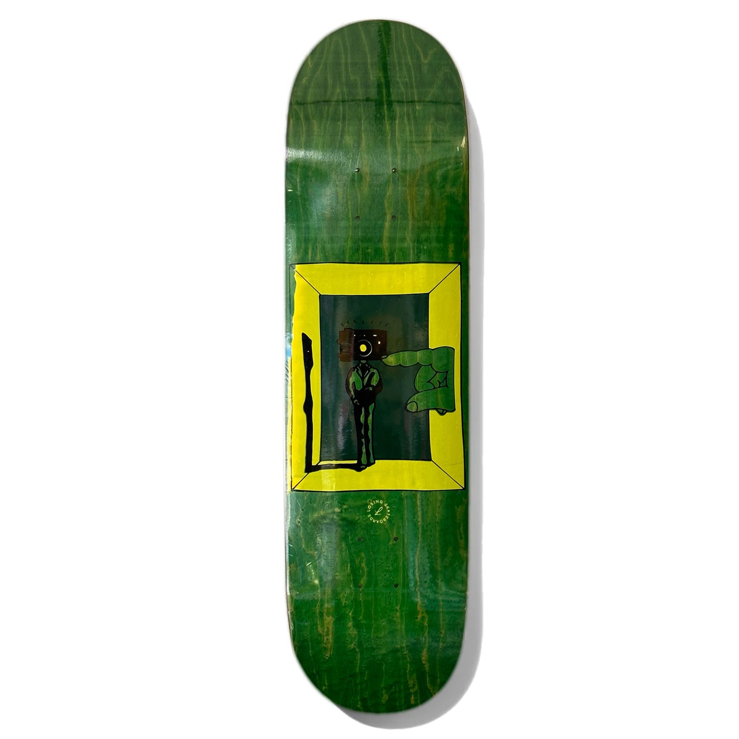 Losing Camera Man Skateboard Deck; Green background; Illustrated multicolored (black, yellow, green) graphic features person in a shadow box with camera instead of head and a larger human hand coming through the wall of the box