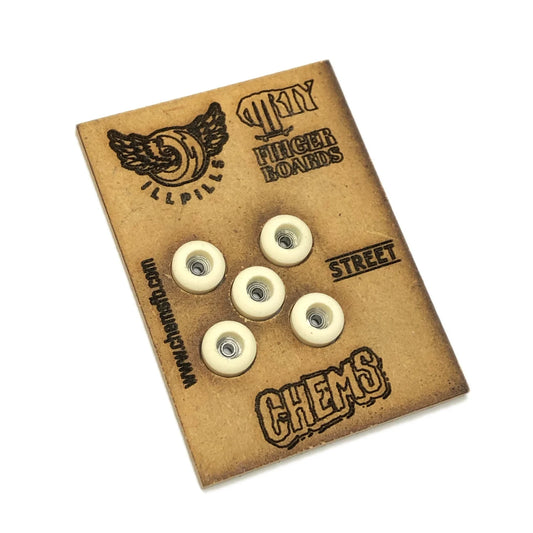 ILLPILLS Urethane Fingerboard Wheels; White-colored wheels displayed in a unique package designed to resemble a piece of wood; Package Engraved with Chems and ILLPILLS logos for added branding; Made from high-quality urethane material for smooth and reliable performance; Enhances fingerboarding experience with improved grip and durability.