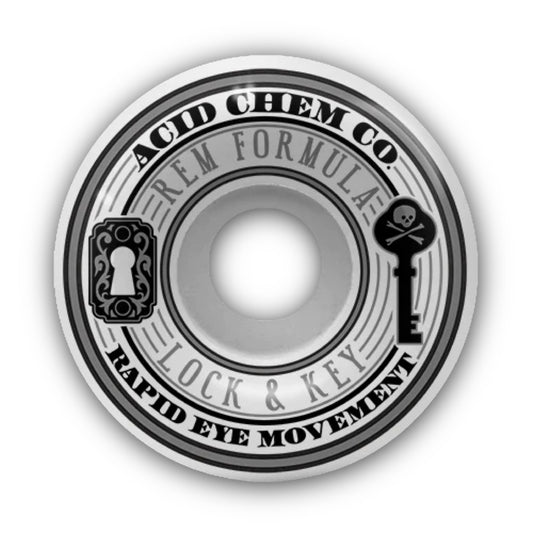 Acid Chemical Co. Lock & Key REM Formula Skateboard Wheels; White skateboard wheel features a side print of a skeleton key and keyhole graphic; Black lettering spells out “Acid Chem Co.” and “Rapid Eye Movement”; grey lettering spells out “REM Formula” and “Lock & Key”