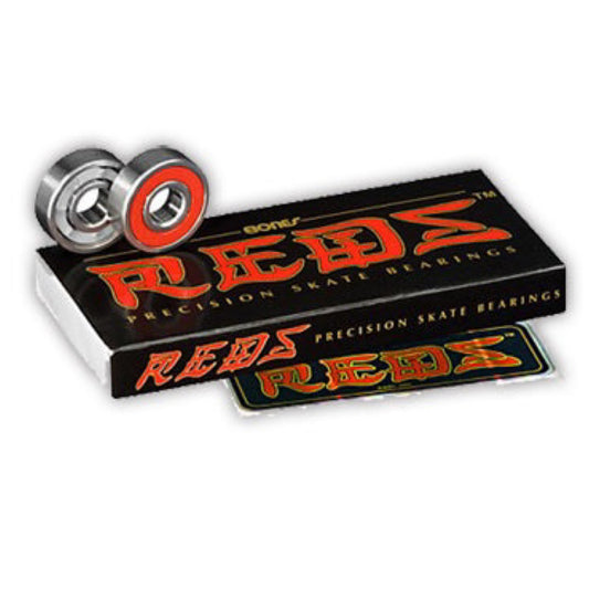 Bones Reds Skateboard Bearings; Precision skate bearings with silver construction and red shields; Black package with red and gold text; Designed for high-performance skateboarding;
